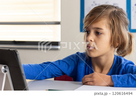 In school, boy using tablet and focusing on learning in classroom 120616494