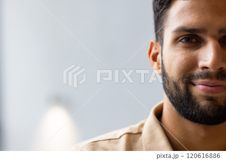 Smiling man with beard looking at camera, close-up portrait in studio, copy space 120616886