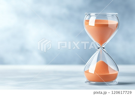 A Close-Up View of an Hourglass with Flowing Sand Capturing the Essence of Time and Measurement in a Serene Setting for Artistic and Conceptual Use 120617729