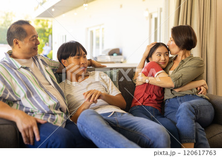 Relaxing on couch, happy family bonding and spending quality time together Relaxing on couch, happy family bonding and spending quality time together 120617763