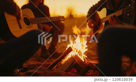 Team bonding around a campfire with acoustic music at sunset 120618039