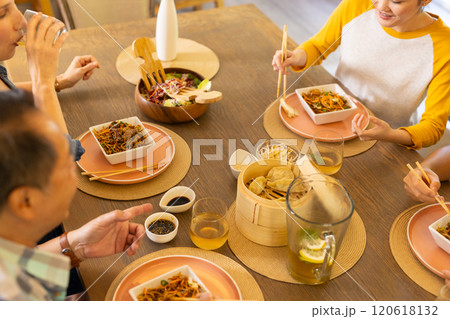 At home, Eating Asian cuisine, asian family enjoying meal together with chopsticks at dining table 120618132