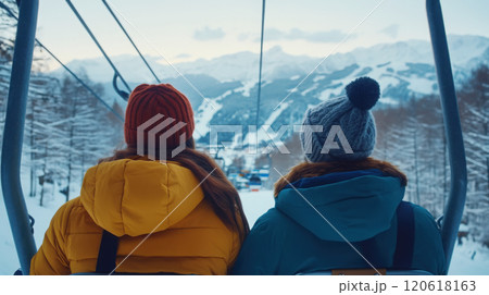 Couple enjoying scenic ski lift ride in winter wonderland Couple enjoying scenic ski lift ride in winter wonderland 120618163