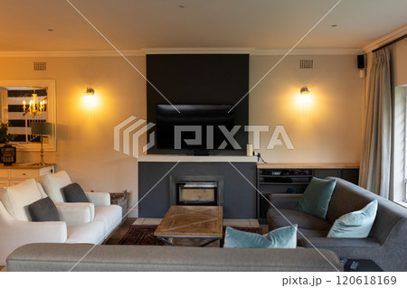 At home, Modern living room with comfortable sofas and large flat-screen TV on wall, copy space 120618169