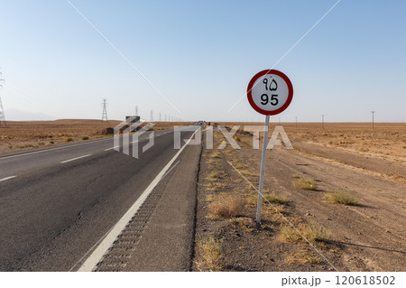 Speed limit sign on a deserted road in the Iranian desert under a clear blue sky Speed limit sign on a deserted road in the Iranian desert under a clear blue sky 120618502