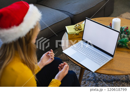 Happy caucasian woman in santa hat having video call and smiling at christmas at home 120618799