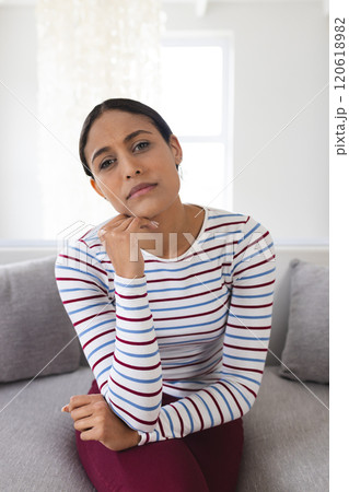 Portrait of sad biracial woman having video call at home Portrait of sad biracial woman having video call at home 120618982