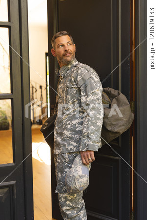 Caucasian male soldier in uniform returning home walking into house 120619133
