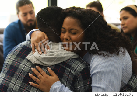 Two african american male and female friends hugging on therapy session Two african american male and female friends hugging on therapy session 120619176
