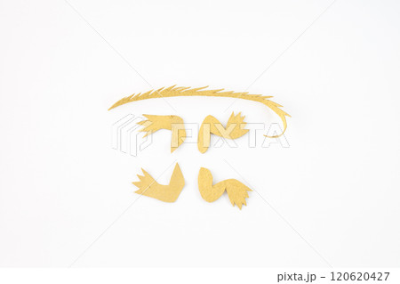 pieces of yellow paper cut into specific shapes. part of a craft project 120620427