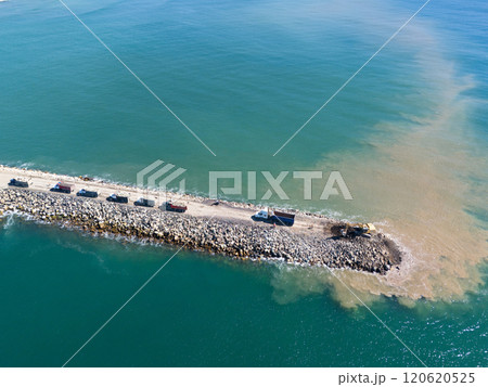 Trucks and excavator making work at sea Trucks and excavator making work at sea 120620525