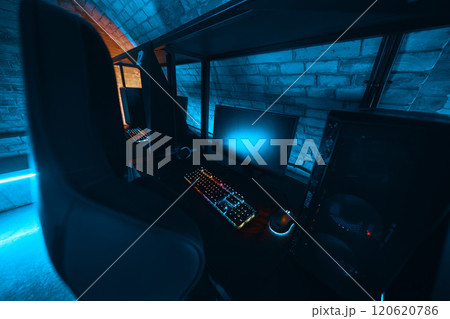 Modern gaming setup with vibrant lighting in a cozy underground room Modern gaming setup with vibrant lighting in a cozy underground room 120620786