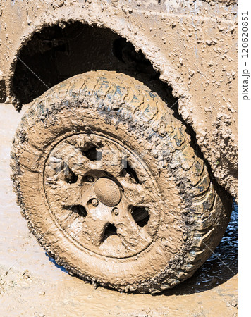 Extremely dirty off-road car wheel after driving heavy off-road 120620851
