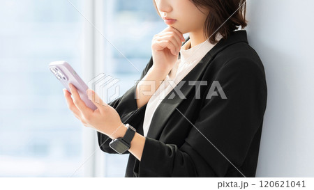 スマホを見て考える女性・ビジネスウーマン 120621041
