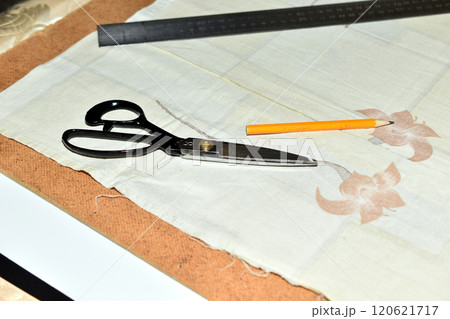 There are things for sewing on the seamstress's table. 120621717