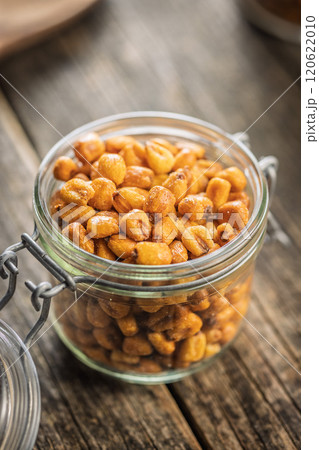 Roasted salted corn snack in jar on wooden table. Roasted salted corn snack in jar on wooden table. 120622010