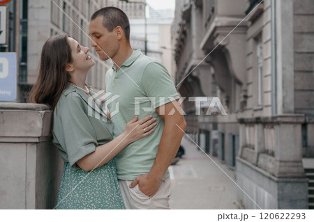 Happy couple of tourists walking embraced while sightseeing the town. Happy couple in front of palace of culture and science in Warsaw, Poland. Close up of a couple kissing. Happy couple of tourists walking embraced while sightseeing the town. Happy couple in front of palace of culture and science in Warsaw, Poland. Close up of a couple kissing. 120622293