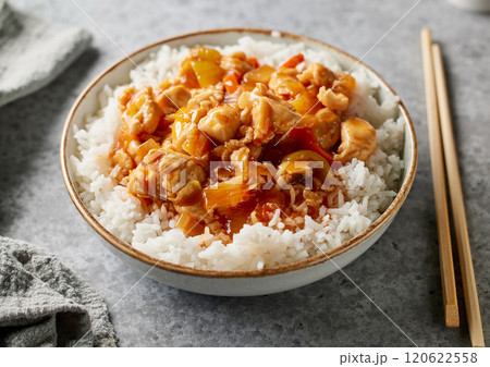 bowl of boiled rice with chicken sweet and sour sauce 120622558