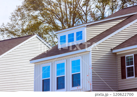 Residential building roof highlights modern windows amid suburban setting architecture features clean lines, neutral tones 120622700