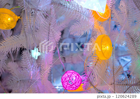 Christmas background with fluffy white Christmas tree and glowing garlands toys. High quality photo 120624289