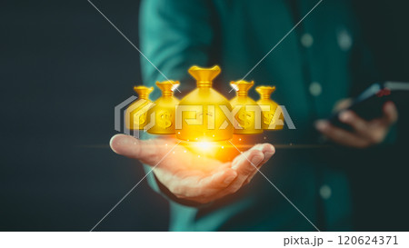 Hand holding glowing golden money bags with dollar signs, symbolizing wealth, financial success, and growth. The image conveys the power of investment and prosperity in a modern, digital economy. Hand holding glowing golden money bags with dollar signs, symbolizing wealth, financial success, and growth. The image conveys the power of investment and prosperity in a modern, digital economy. 120624371
