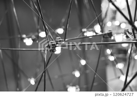 abstract background is a metal structure made of thin rods with light bulbs in a geometric sequence. strange art objects for home and office. High quality photo 120624727