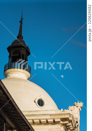 Historical building dome under clear sky with moon visible Historical building dome under clear sky with moon visible 120626082