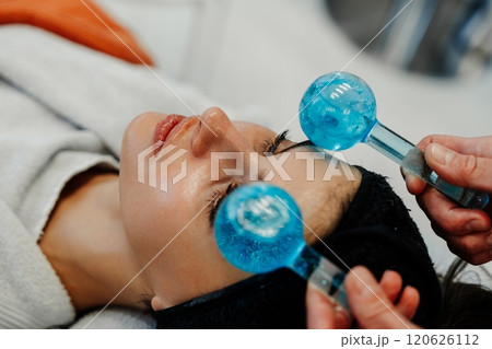Relaxing facial treatment with cooling tools in a wellness center 120626112
