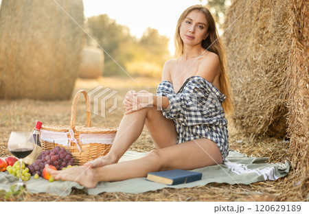 Young woman in shirt sitting during picnic 120629189