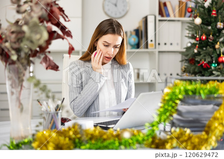 Unhappy business woman working during Christmas 120629472
