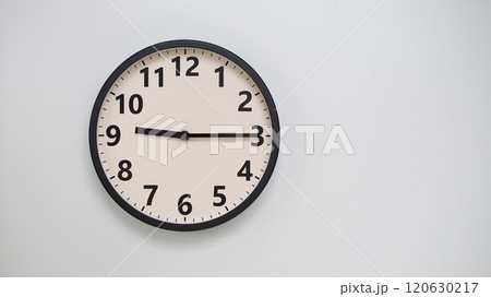 Classic Black-Edged Clock on White Background at 21.15/09.15 - Perfect for Time Management and Text Space 120630217