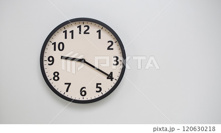 Classic Black-Edged Clock on White Background at 21.20/09.20 - Perfect for Time Management and Text Space 120630218