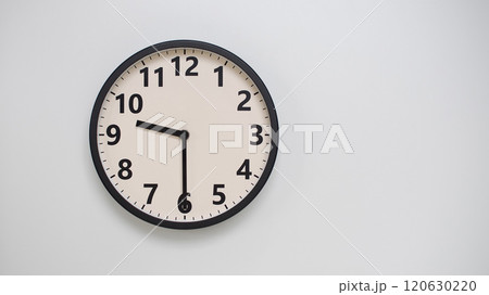 Classic Black-Edged Clock on White Background at 21.30/09.30 - Perfect for Time Management and Text Space 120630220
