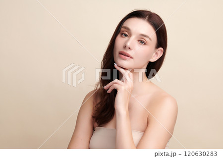 Beautiful young woman with clean fresh skin on beige background, Face care, Facial treatment, Cosmetology, beauty and spa, women portrait. 120630283