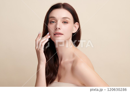 Beautiful young woman with clean fresh skin on beige background, Face care, Facial treatment, Cosmetology, beauty and spa, women portrait. 120630286