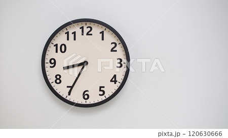 Classic Black-Edged Clock on White Background at 20.35/08.35 - Perfect for Time Management and Text Space 120630666