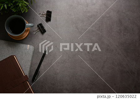 Stylish office desk with cup of coffee and leather journal with a pen. Space for text Stylish office desk with cup of coffee and leather journal with a pen. Space for text 120635022