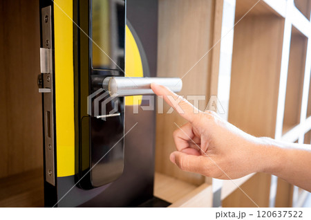 Customer hand pointing at door handle of smart digital door lock 120637522
