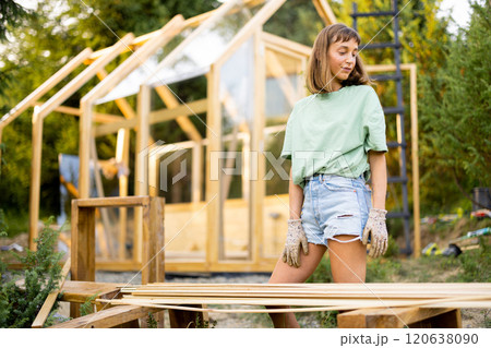 Female Carpenter in Backyard 120638090
