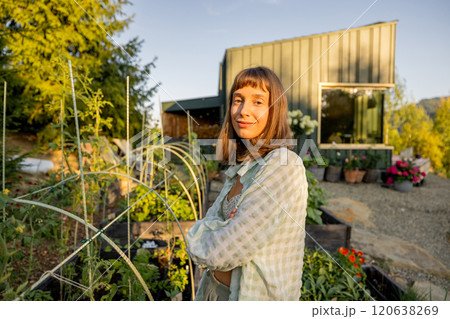 Woman Smiling in Garden by Modern Cabin 120638269