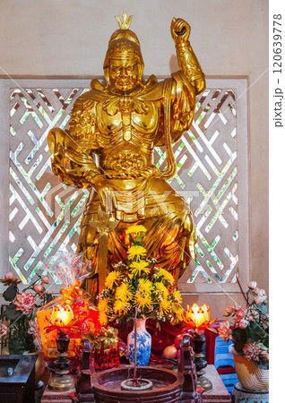 Golden statue of a warrior inside a temple on Buddhist pagoda in Vietnam in Asia Golden statue of a warrior inside a temple on Buddhist pagoda in Vietnam in Asia 120639778