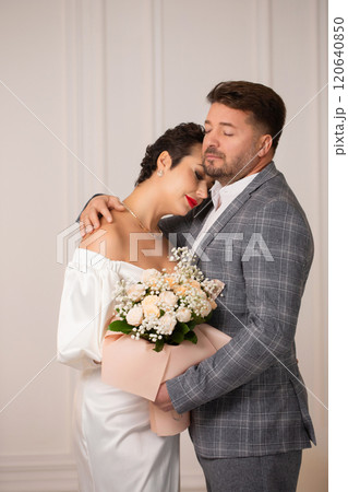 The groom gently hugged the bride The groom gently hugged the bride 120640850
