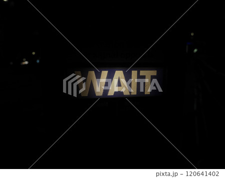 Wait sign at pedestrian crossing at night in London Wait sign at pedestrian crossing at night in London 120641402