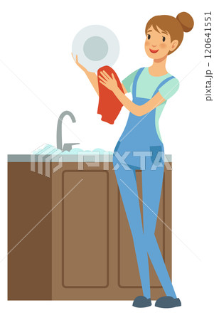 A woman is washing a plate in a sink A woman is washing a plate in a sink 120641551