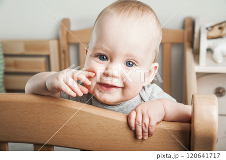 Curious Baby Standing in a Wooden Crib Curious Baby Standing in a Wooden Crib 120641717