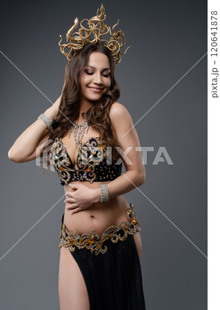 Elegant dancer showcasing elaborate costume and headdress in graceful pose 120641878