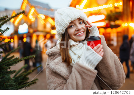 Woman enjoying winter moments. Festive Christmas fair, winter holidays concept. 120642703