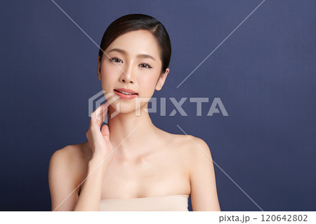 Beautiful young asian woman with clean fresh skin on blue background, Face care, Facial treatment, Cosmetology, beauty and spa, Asian women portrait. 120642802