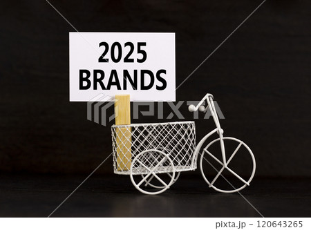 Planning 2025 brands new year symbol. Concept words 2025 Brands on beautiful white paper on wooden clothespin. Bicycle. Beautiful black background. Business 2025 brands new year concept. Copy space. 120643265