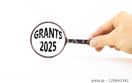 Planning grants 2025 new year symbol. Concept words Grants 2025 on beautiful white paper in magnifying glass. Beautiful white paper background. Business grants 2025 new year concept. Copy space. 120643342
